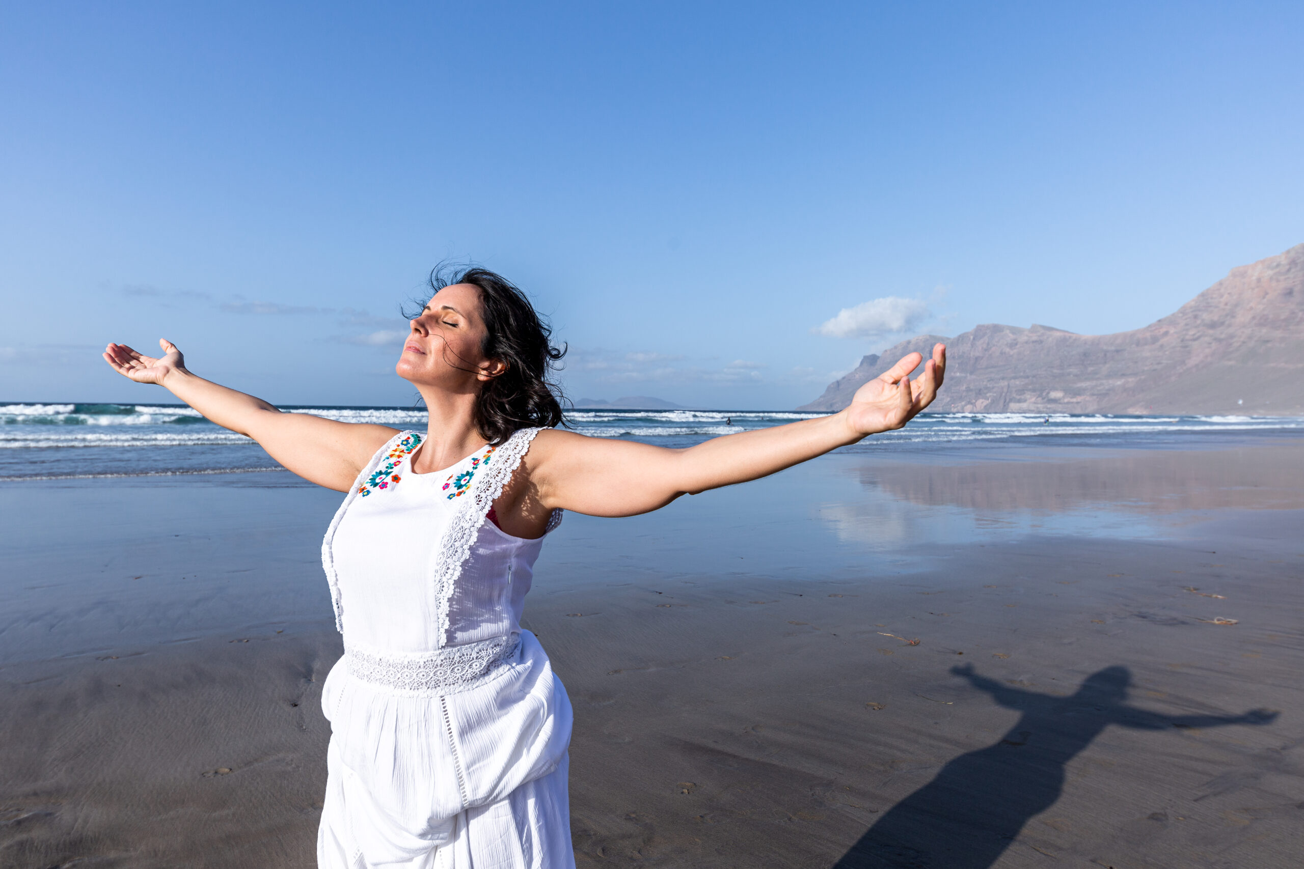 Woman breathing fresh air near sea