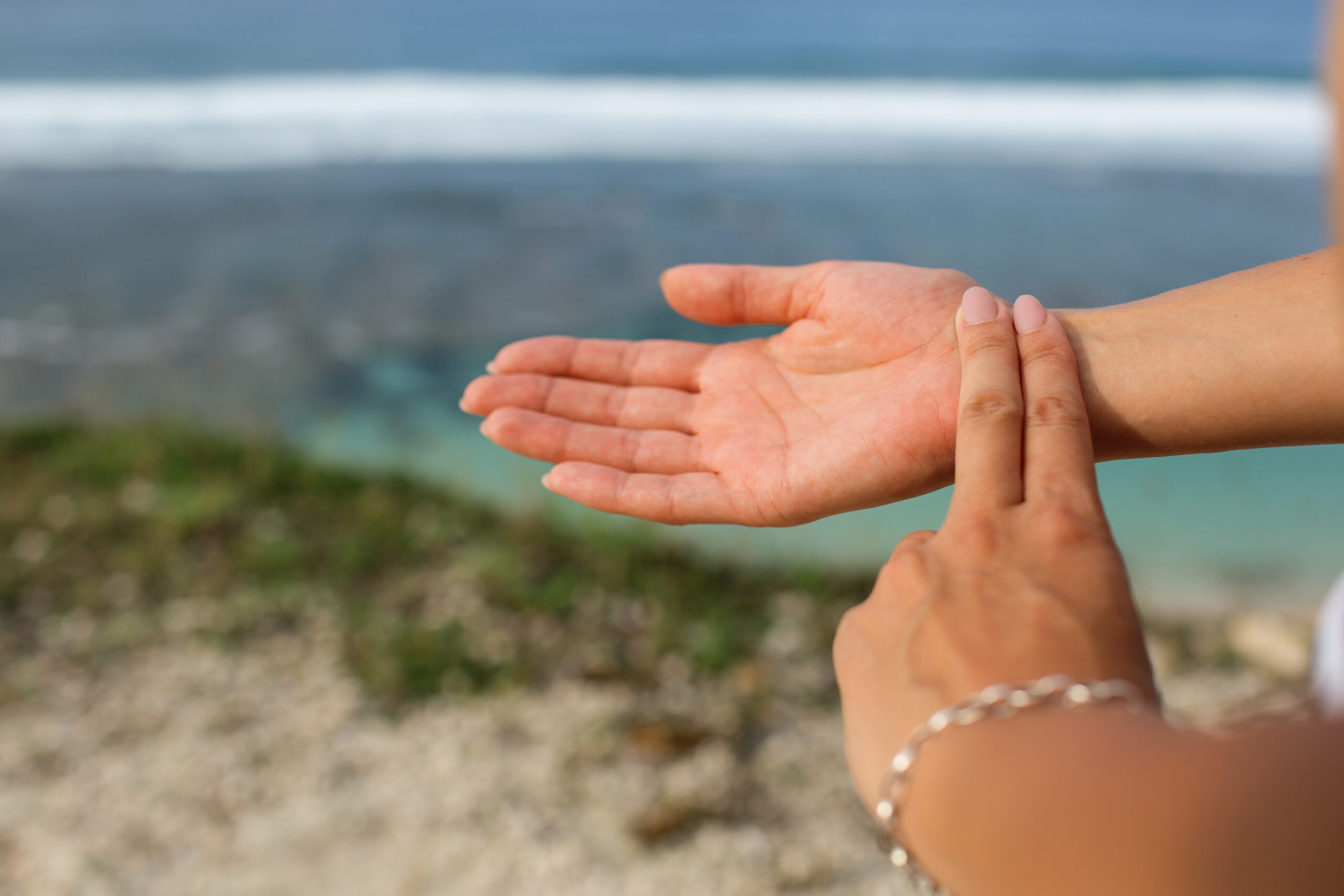 Close-up of hands tapping on wrist, representing EFT stress relief