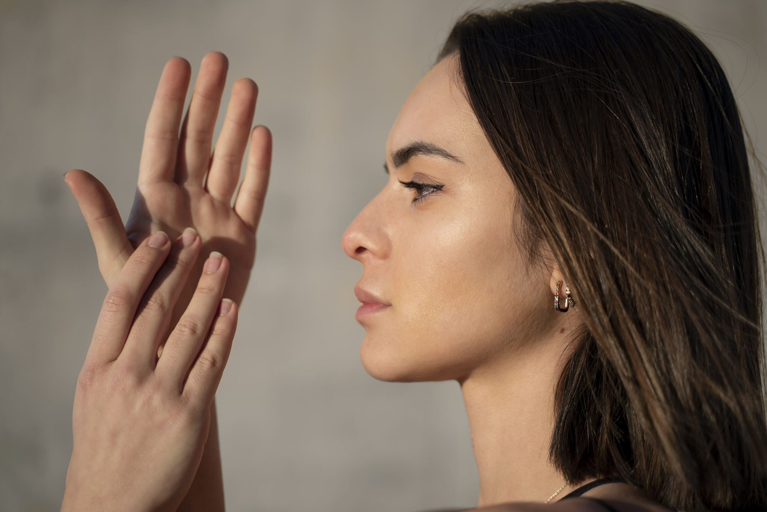 Person practicing tapping exercises on collarbone area at home