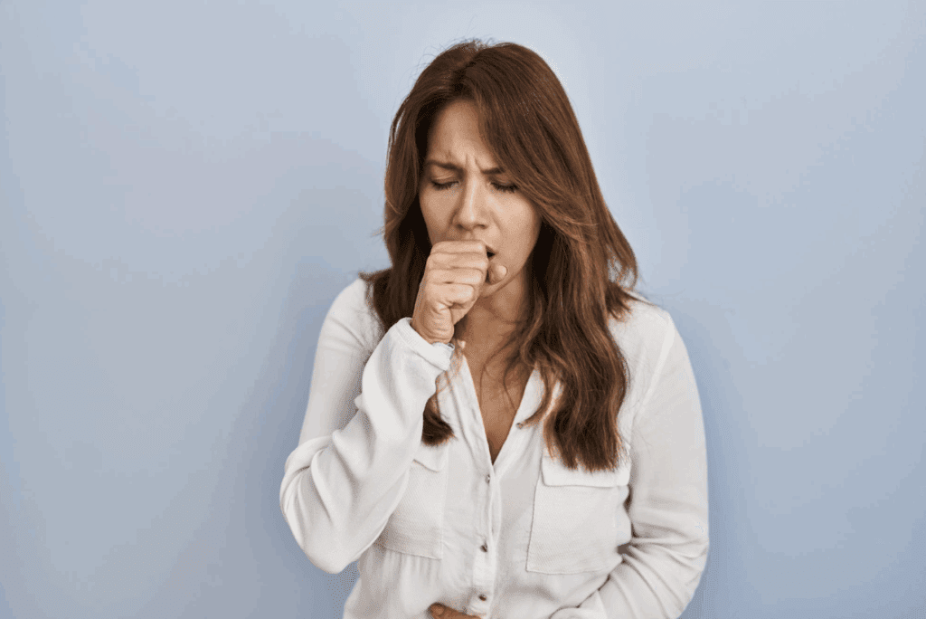 Woman coughing showing dry cough reason
