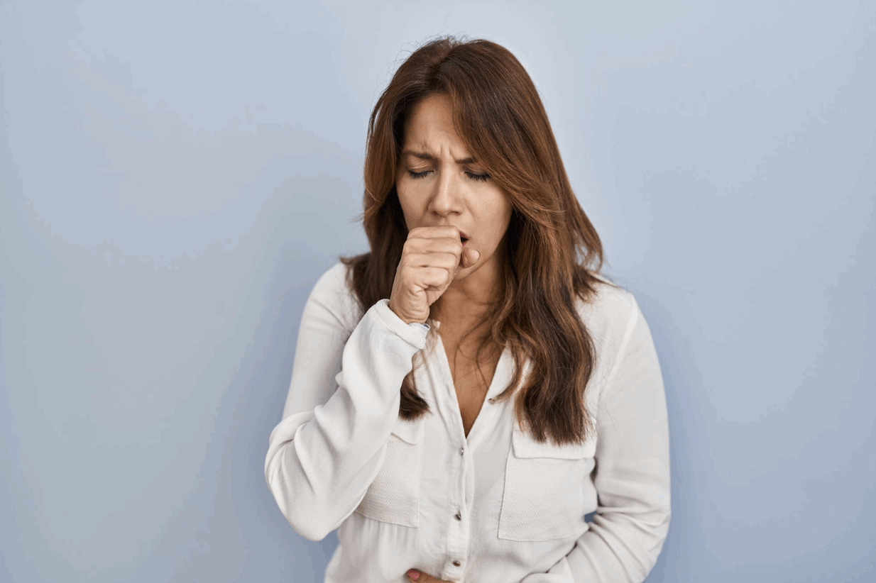 Woman coughing showing dry cough reason