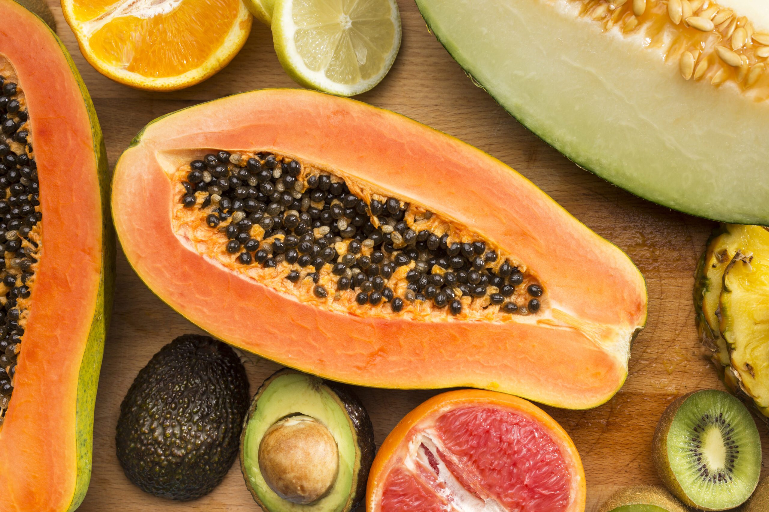 Ripe, Raw, or Juiced? How to Use Papaya to Supercharge Your Health Naturally Ripe papaya cut open showing papaya benefits digestion