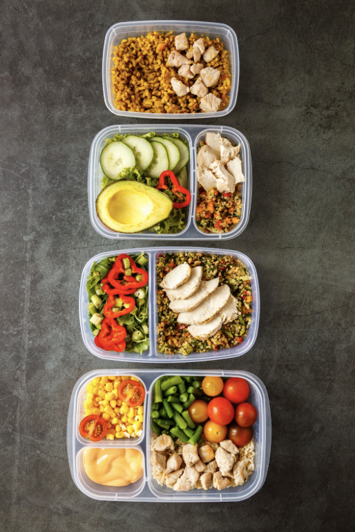 lunch box meal with fruits and snacks arranged neatly