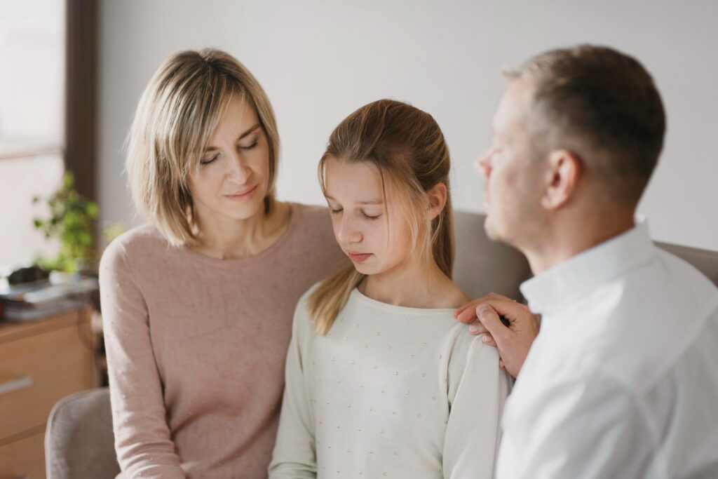 Divorced parents supporting their child together, symbolizing co-parenting