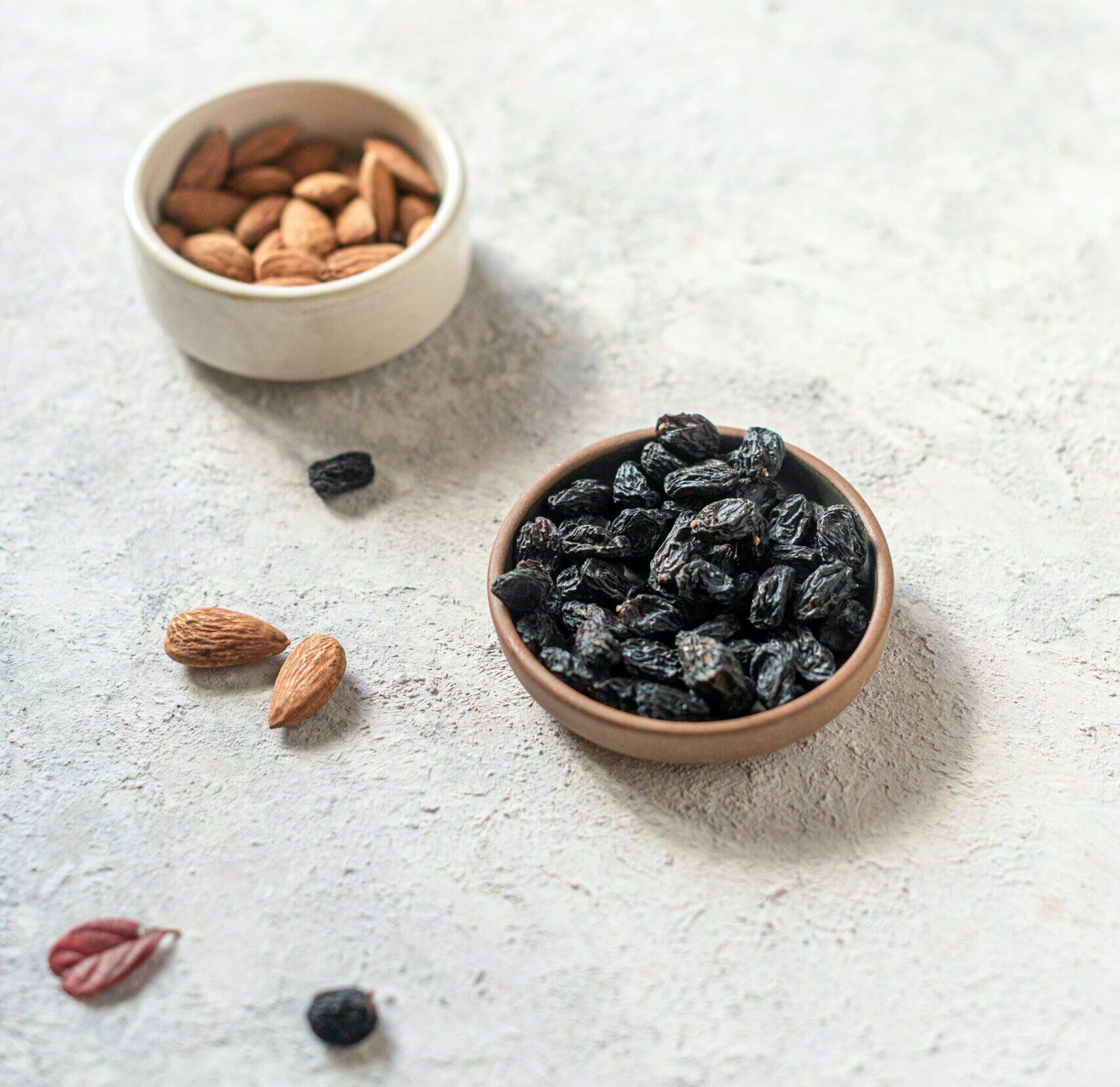 Close-up of raisins and almond on table
