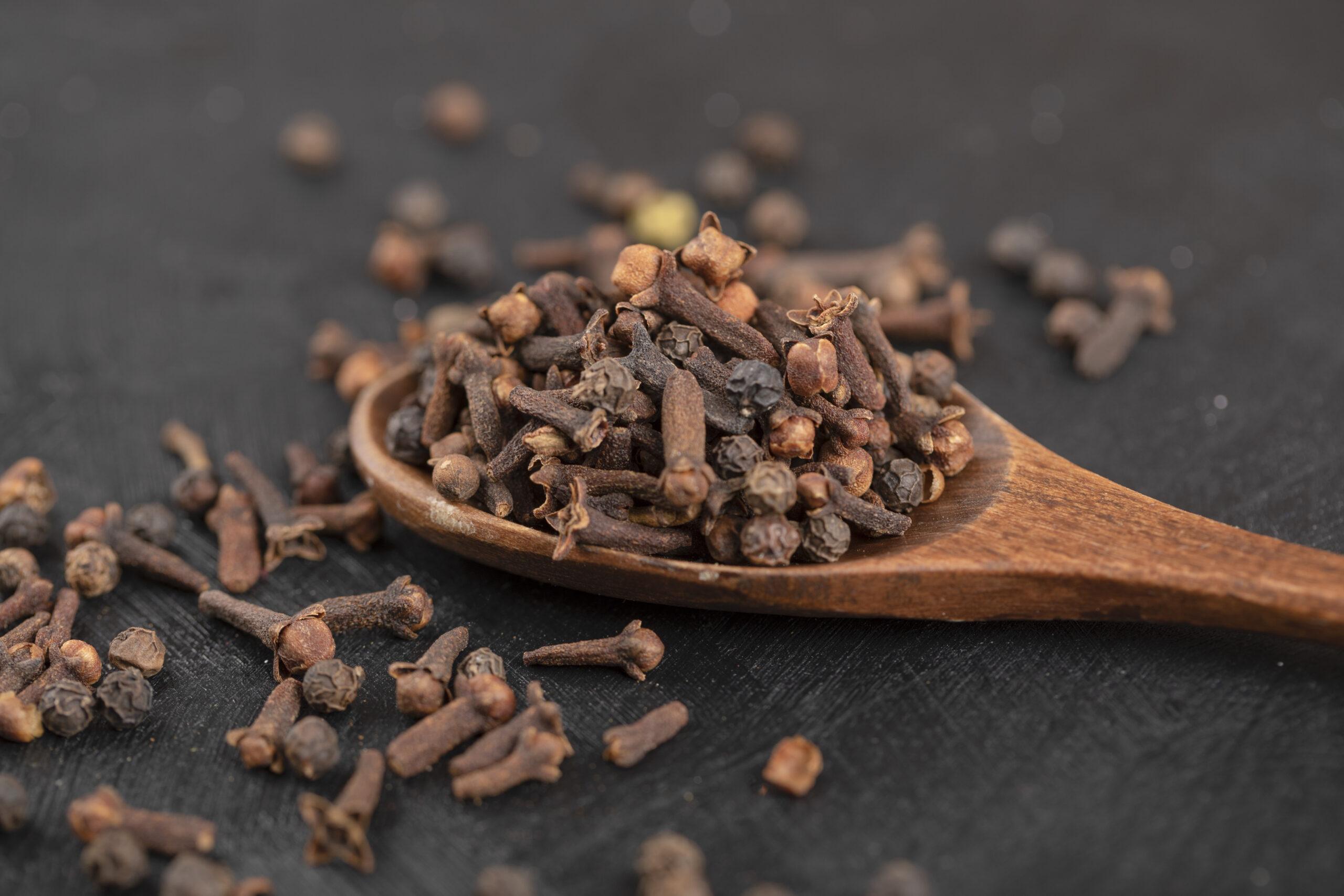 8 Cloves Benefits You Shouldn’t Miss and How to Use Them Right Dried cloves in a wooden spoon showcasing health benefits